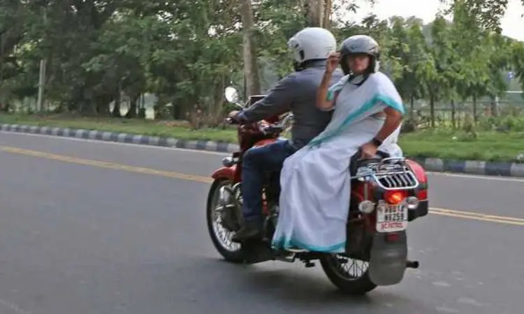 Banerjee rides pillion on motorcycle